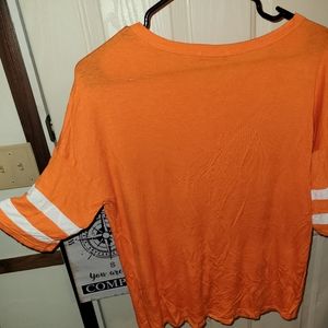 Size small orange with white stripes on the sleeves Zutter brand shirt. NWOT